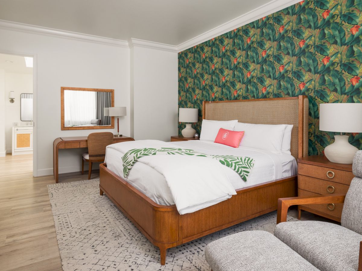 Guest suite with Tommy Bahama palm print wallpaper and king bed