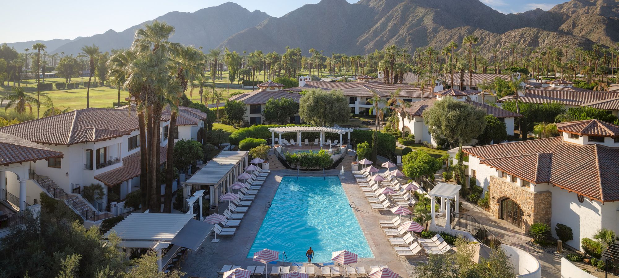 Resort pool surrounded by palms with the Santa Rosa Mountains at Tommy Bahama Miramonte
